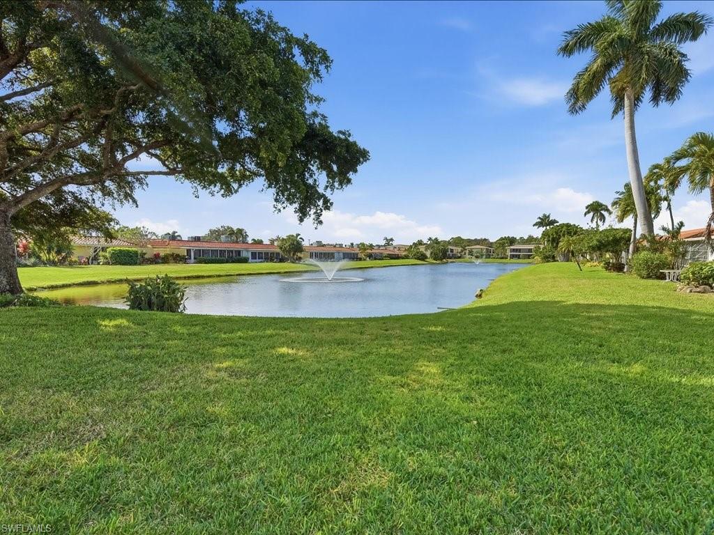 186 Harrison Road, Unit H2 Naples, FL 34112 - Photo 36 of 38 a view of a lake with houses in the back