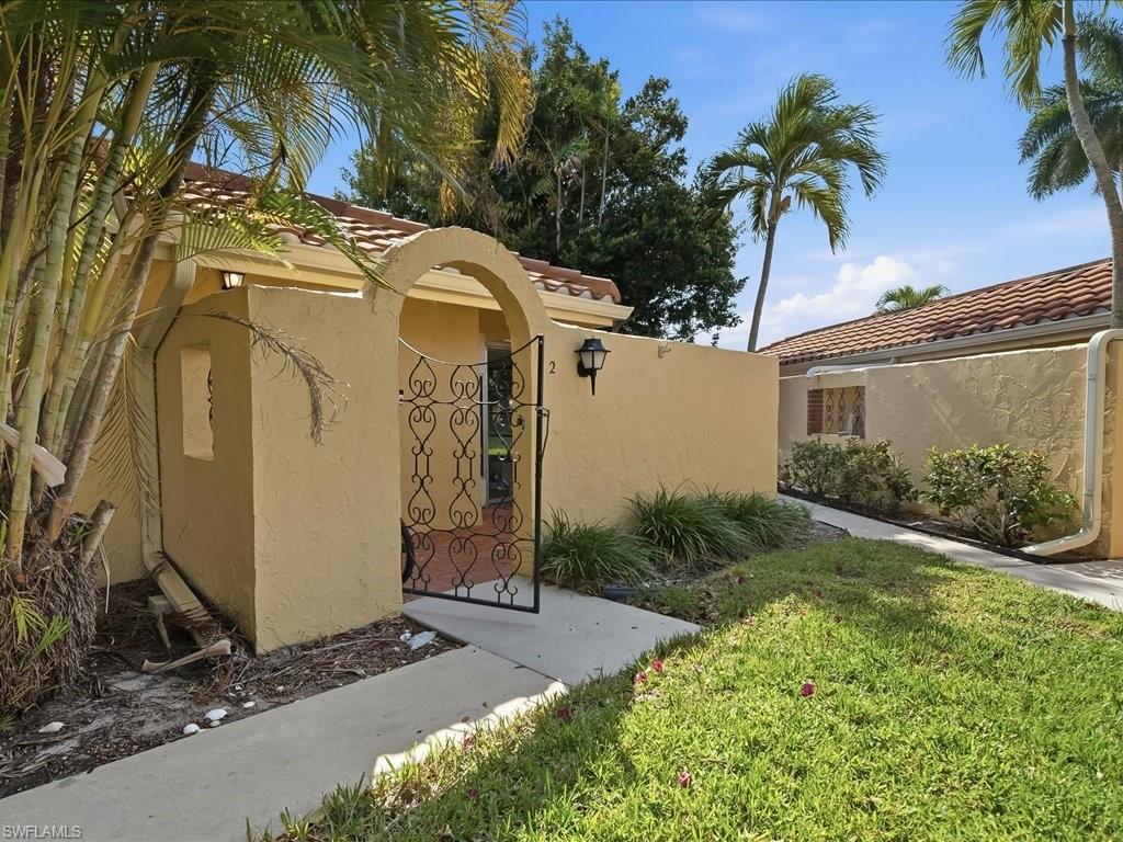 186 Harrison Road, Unit H2 Naples, FL 34112 - Photo 37 of 38 Gate with a yard
