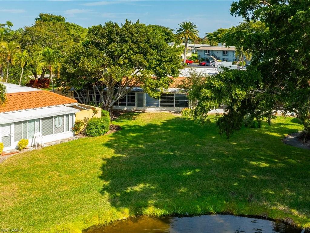 186 Harrison Road, Unit H2 Naples, FL 34112 - Photo 8 of 38 a view of house with a big yard