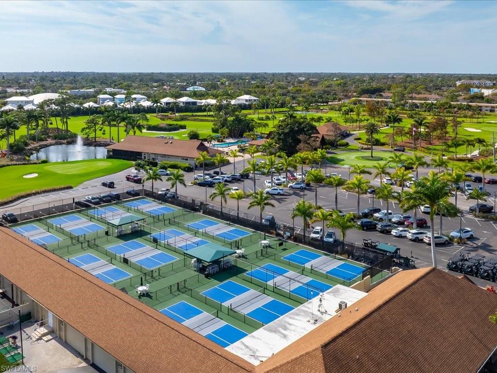 186 Harrison Road, Unit H2 Naples, FL 34112 - Photo 9 of 38 Aerial perspective of suburban area featuring a golf course and a nearby body of water