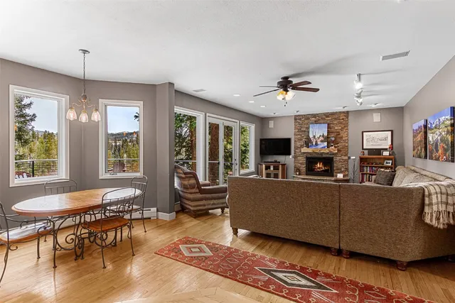 a living room with furniture a window and a chandelier