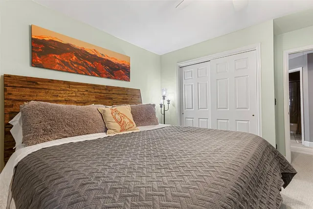 a large bed sitting in a bedroom and table