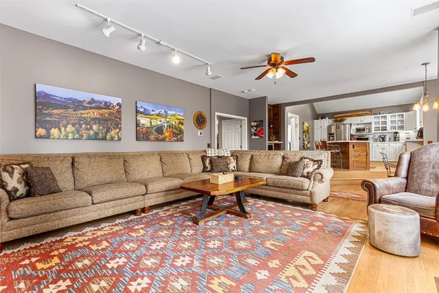 a living room with furniture a rug and a chandelier