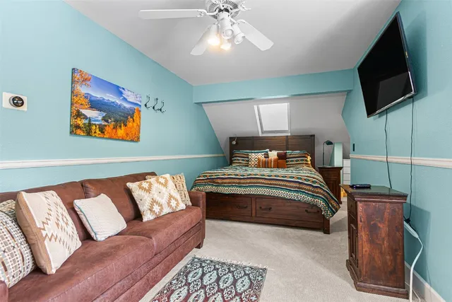 a bedroom with a large bed and a flat screen tv