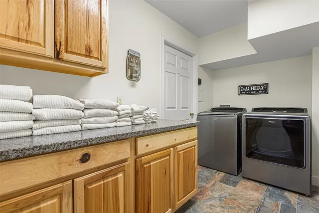 a kitchen with granite countertop a sink and cabinets