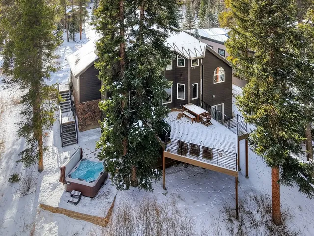 a view of a roof deck with table and chairs and wooden floor