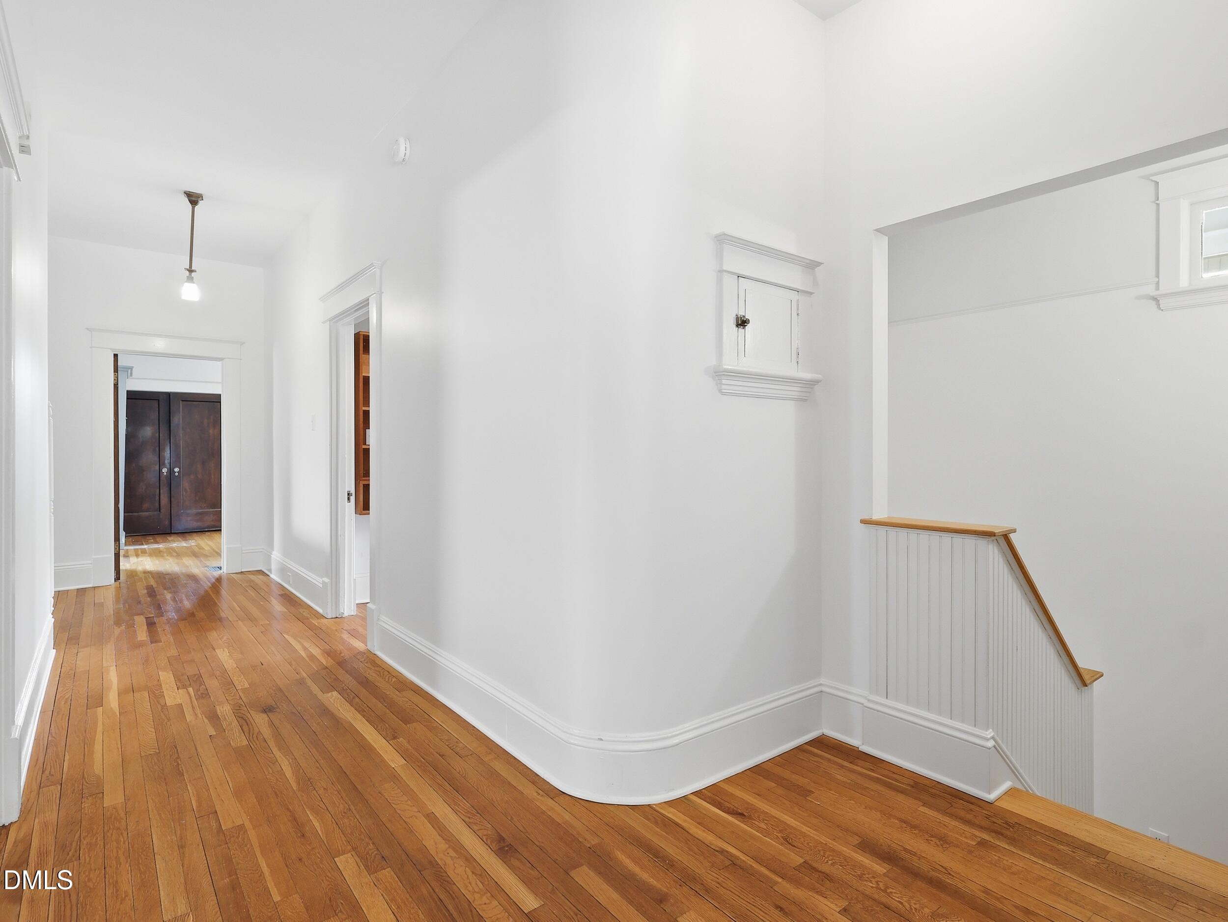 127 Forest Road Raleigh, NC 27605 - Photo 42 of 75 a view of a room with wooden floor and white walls