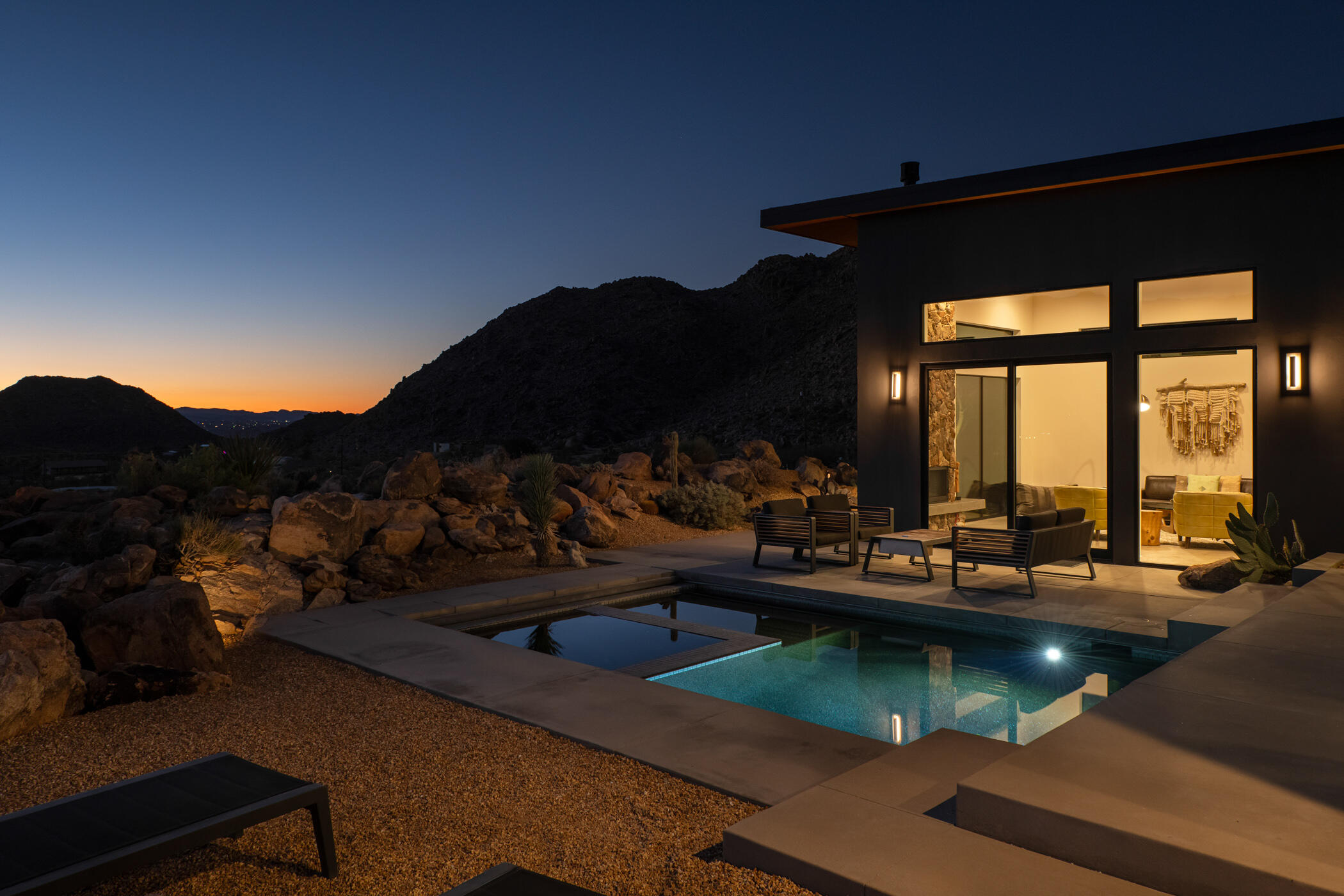 a view of swimming pool with outdoor seating and mountain view