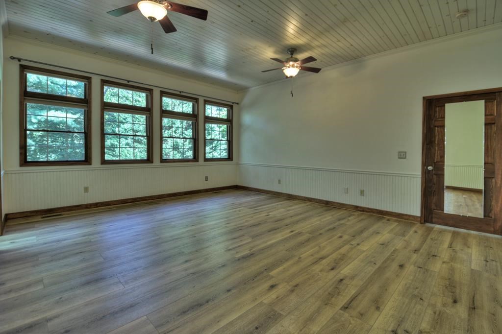 233 Twin Lakes Road Blue Ridge, GA 30513 - Photo 54 of 73 wooden floor in an empty room with a window