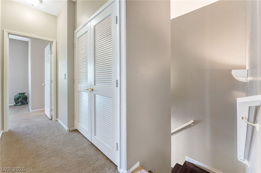 6317 Snap Ridge Street, Unit 101 North Las Vegas, NV 89081 - Photo 12 of 40 Upstairs hallway shows the stairs and laundry closet.