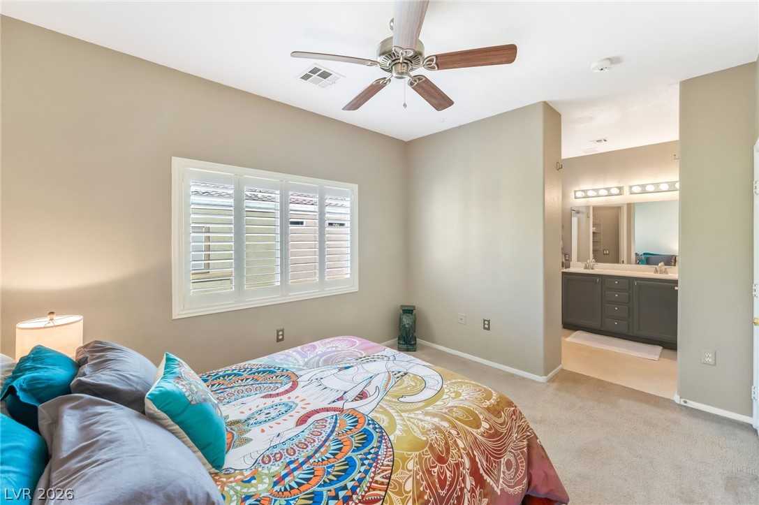 6317 Snap Ridge Street, Unit 101 North Las Vegas, NV 89081 - Photo 15 of 40 Primary suite features shutters, neutral paint, and celing fan.