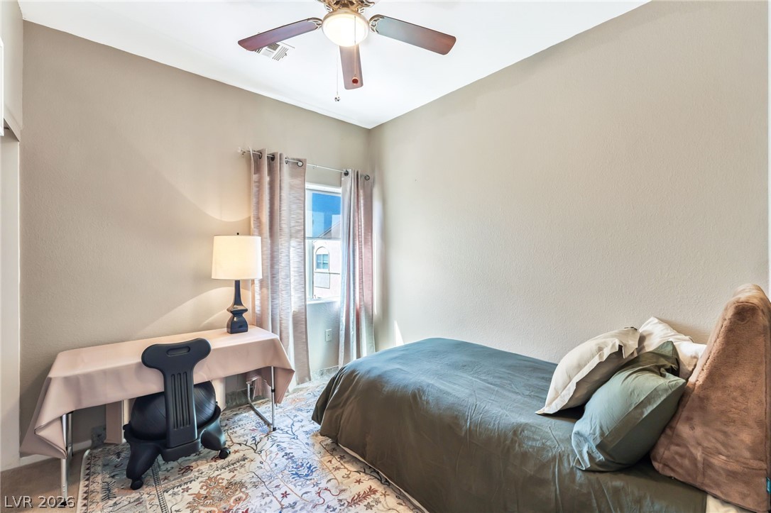 6317 Snap Ridge Street, Unit 101 North Las Vegas, NV 89081 - Photo 17 of 40 Secondary bedroom with ceiling fan and closet.