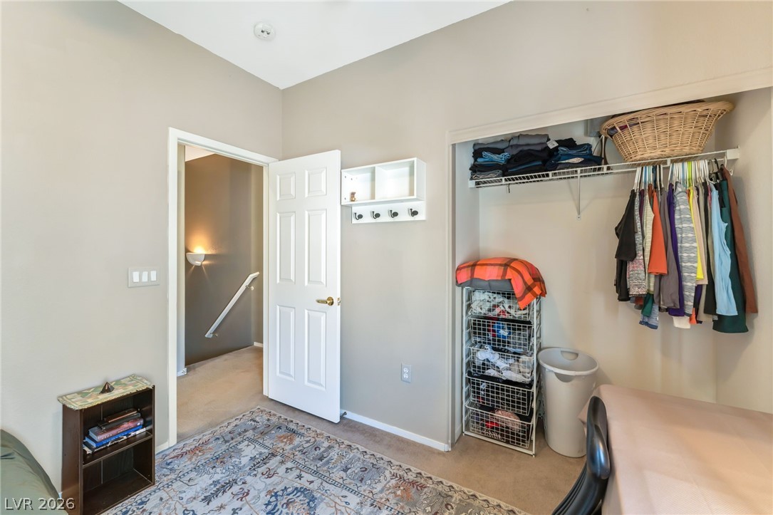 6317 Snap Ridge Street, Unit 101 North Las Vegas, NV 89081 - Photo 18 of 40 Secondary bedroom with ceiling fan and closet.