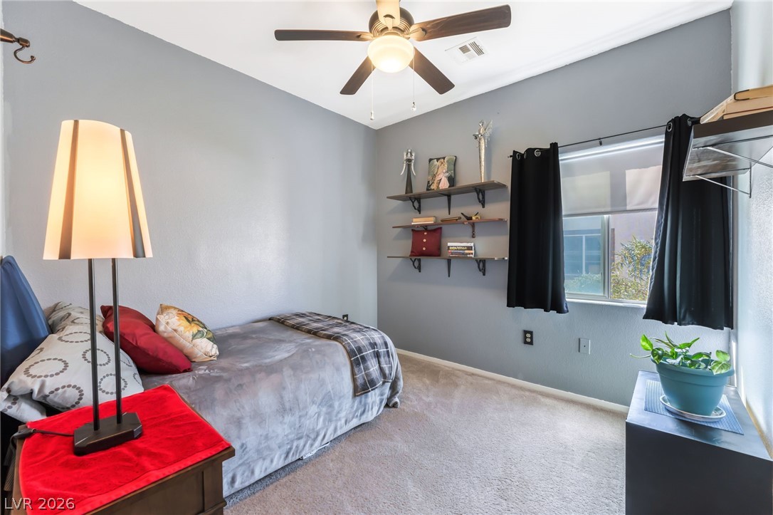 6317 Snap Ridge Street, Unit 101 North Las Vegas, NV 89081 - Photo 19 of 40 Secondary bedroom with ceiling fan and closet.