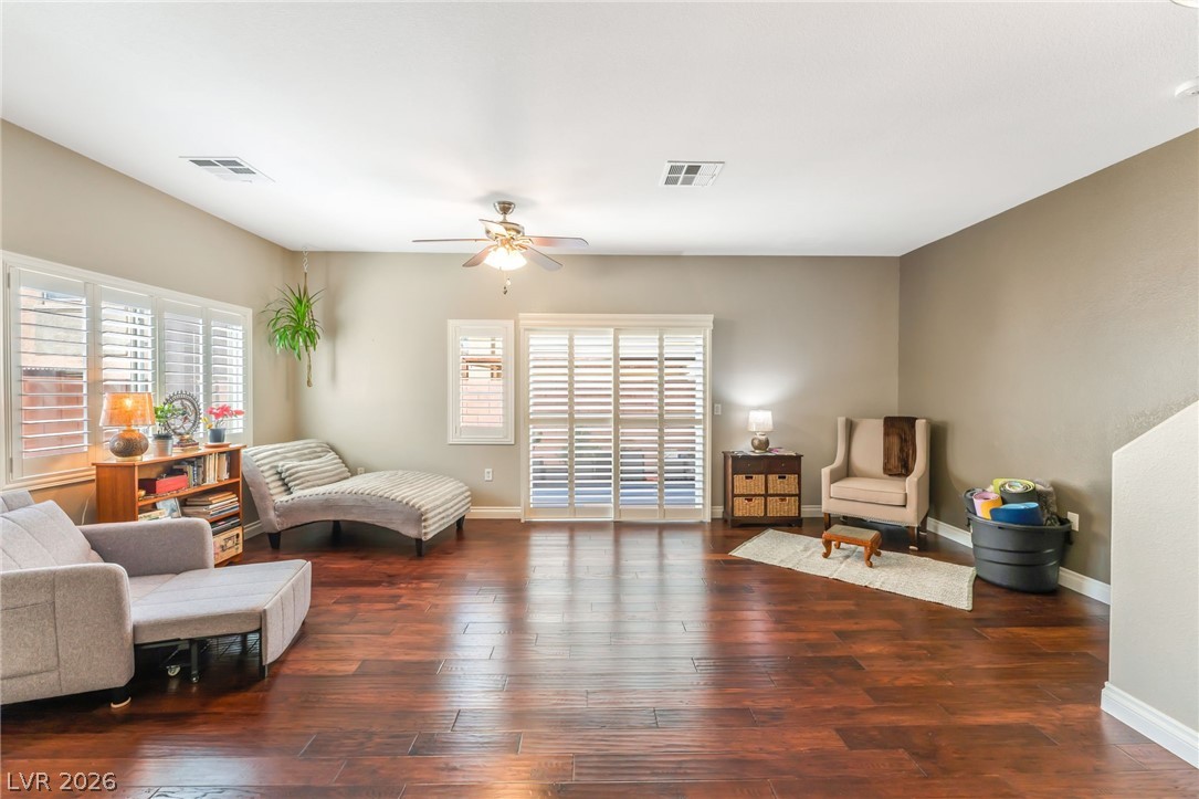 6317 Snap Ridge Street, Unit 101 North Las Vegas, NV 89081 - Photo 2 of 40 Spacious living area is part of the open concept living featuring shutters and access to the private backyard.