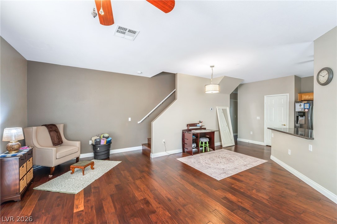 6317 Snap Ridge Street, Unit 101 North Las Vegas, NV 89081 - Photo 3 of 40 Spacious living area is part of the open concept living featuring shutters and an open dining area.