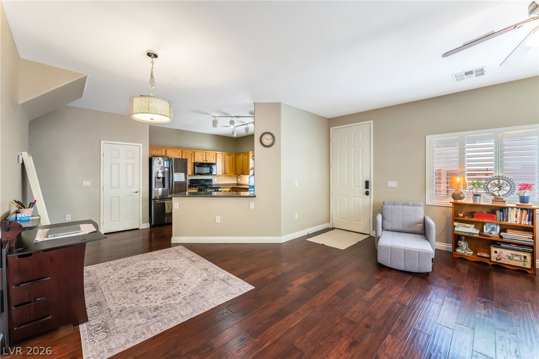 6317 Snap Ridge Street, Unit 101 North Las Vegas, NV 89081 - Photo 4 of 40 Spacious living area is part of the open concept living featuring shutters and the dining area.
