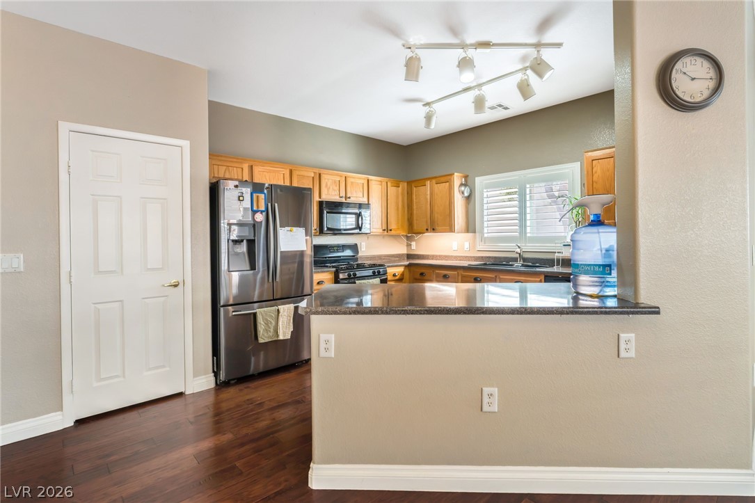 6317 Snap Ridge Street, Unit 101 North Las Vegas, NV 89081 - Photo 6 of 40 Kitchen has ample counter space and countertop seating area.