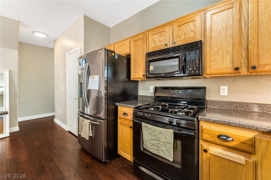 6317 Snap Ridge Street, Unit 101 North Las Vegas, NV 89081 - Photo 9 of 40 Gas stove, built in microwave, and ample storage space.
