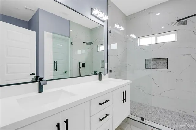 a bathroom with a sink double vanity and a mirror