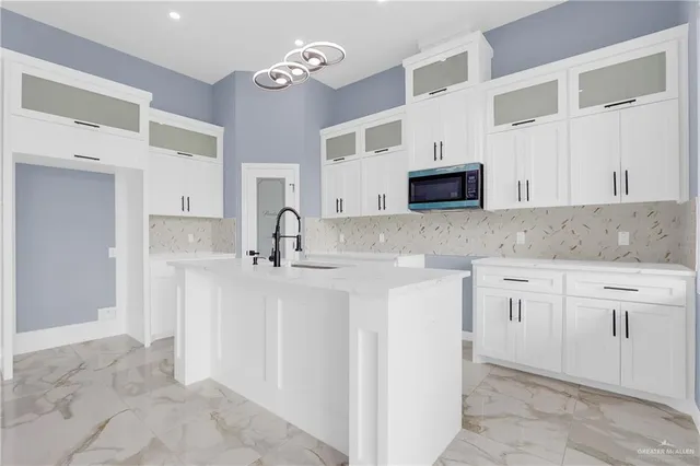 a kitchen with cabinets and window