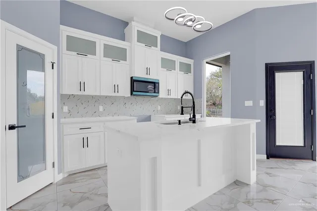 a kitchen with stainless steel appliances granite countertop a sink and cabinets