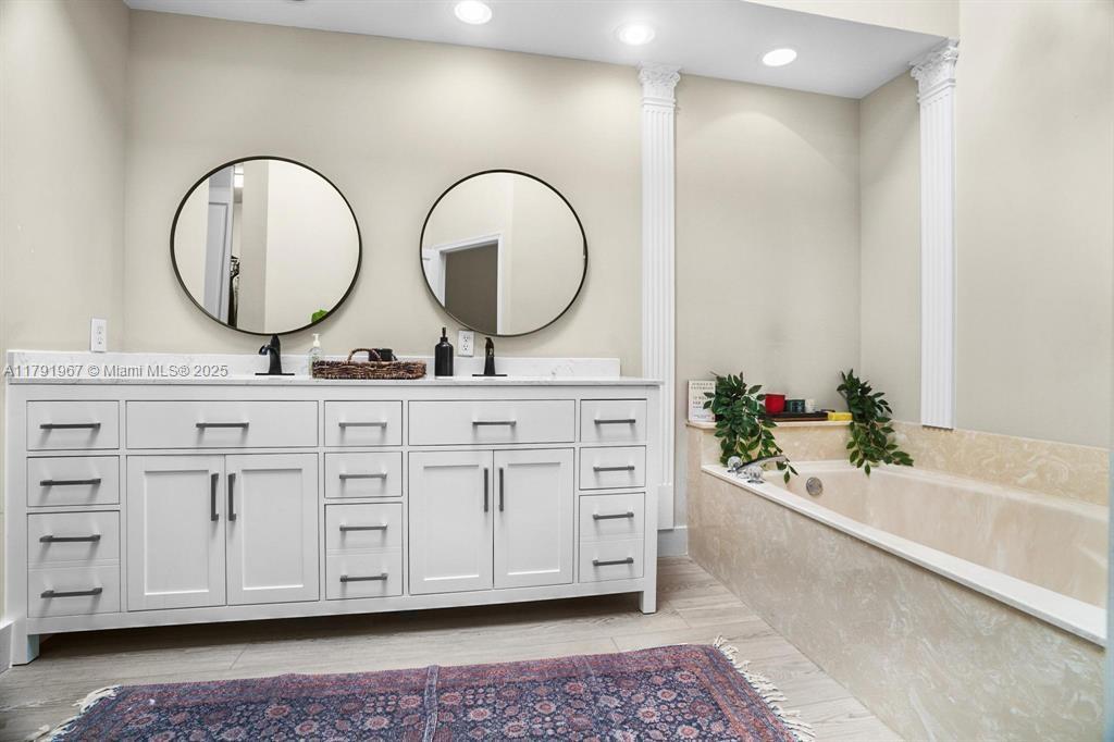 6375 Northwest 24th Street Boca Raton, FL 33434 - Photo 11 of 13 a bathroom with a double vanity sink mirror and bathtub