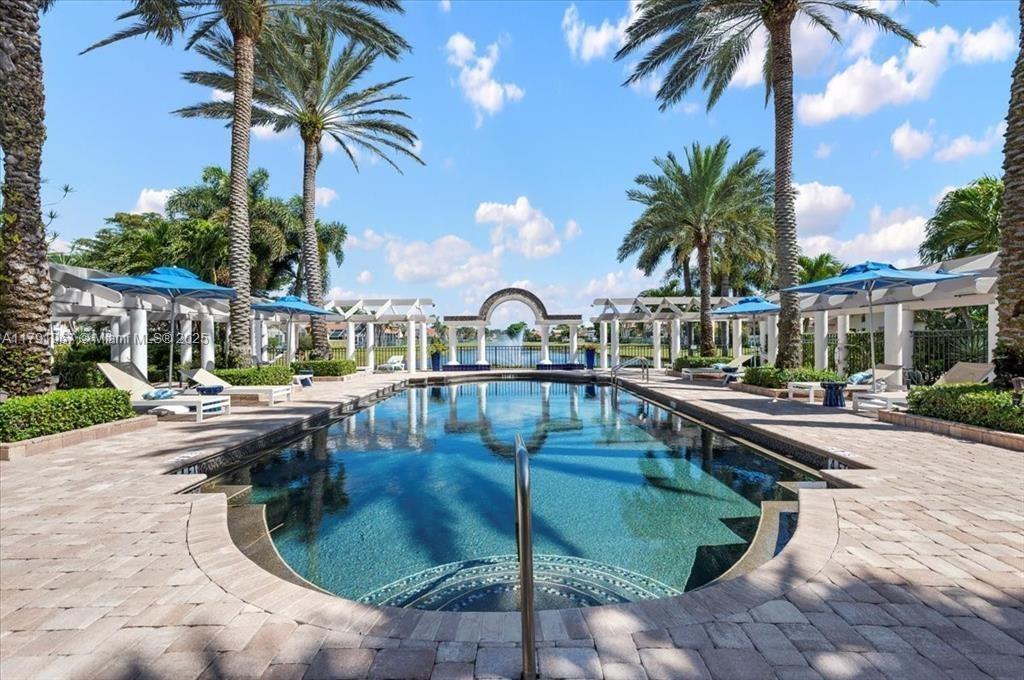 6375 Northwest 24th Street Boca Raton, FL 33434 - Photo 13 of 13 a view of swimming pool that has lawn chairs with plants and palm trees