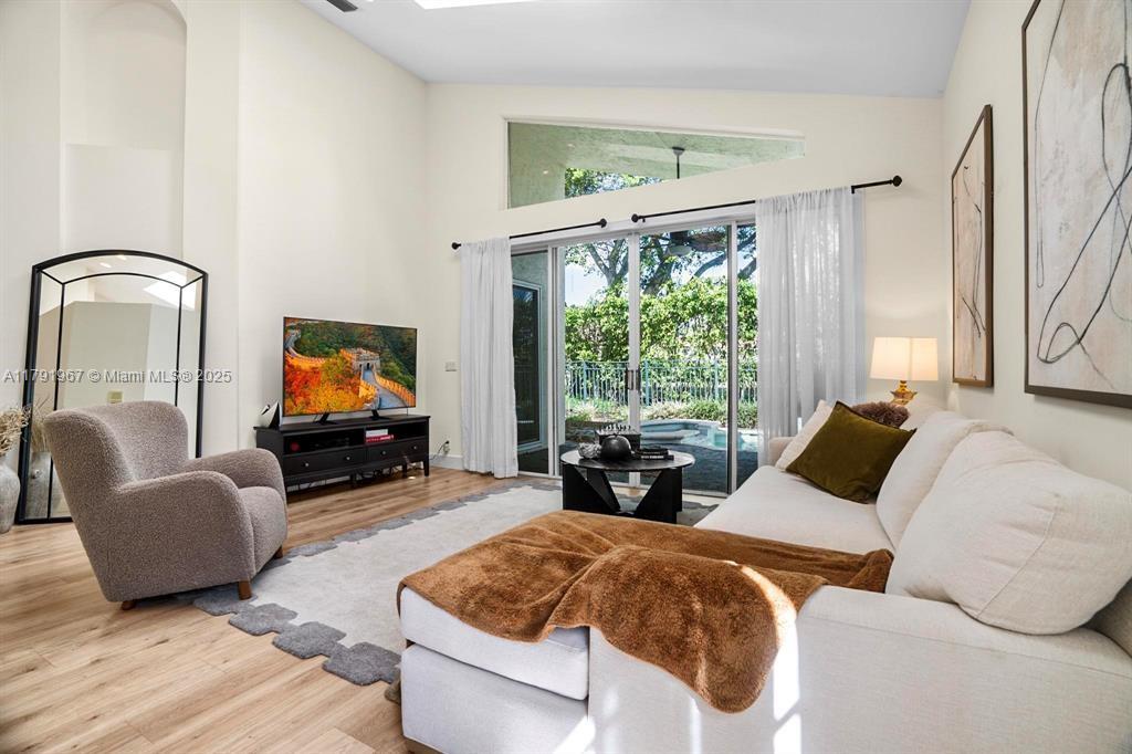 6375 Northwest 24th Street Boca Raton, FL 33434 - Photo 7 of 13 a living room with furniture and a flat screen tv