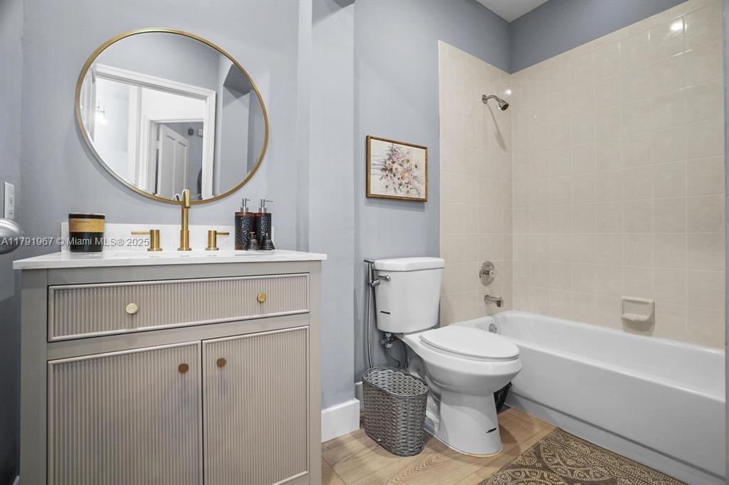 6375 Northwest 24th Street Boca Raton, FL 33434 - Photo 10 of 13 a bathroom with a toilet sink and mirror