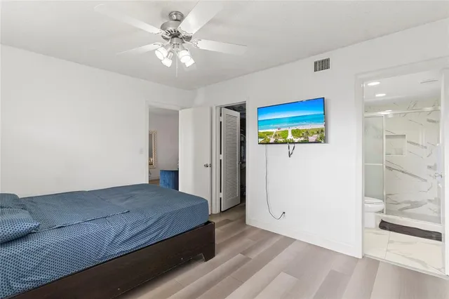 a living room with hard wood floors and a ceiling fan
