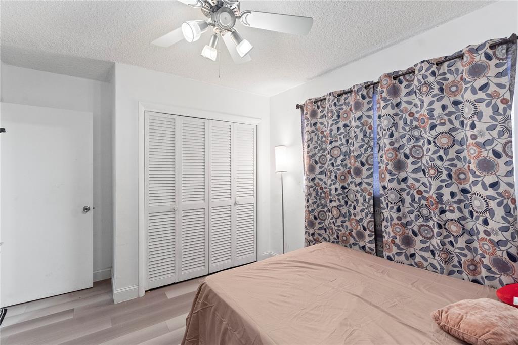 5800 Margate Boulevard, Unit 3463 Margate, FL 33063 - Photo 18 of 37 a bedroom with a bed and a chandelier
