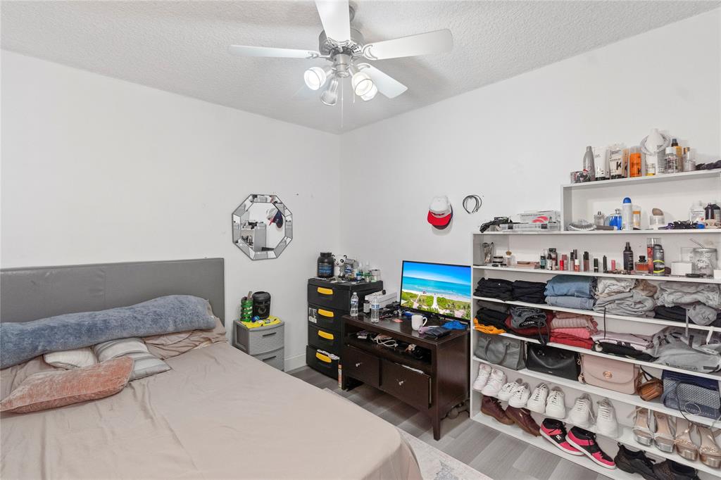 5800 Margate Boulevard, Unit 3463 Margate, FL 33063 - Photo 19 of 37 a bedroom with bed and a chandelier