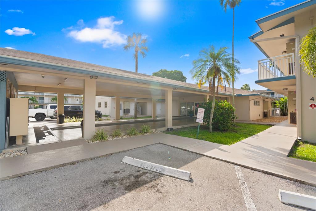 5800 Margate Boulevard, Unit 3463 Margate, FL 33063 - Photo 29 of 37 a front view of a house with a yard and potted plants