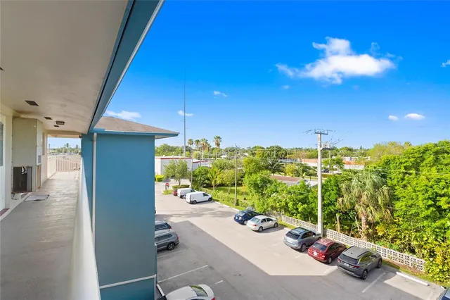 a view of a livingroom with furniture and a floor to ceiling window