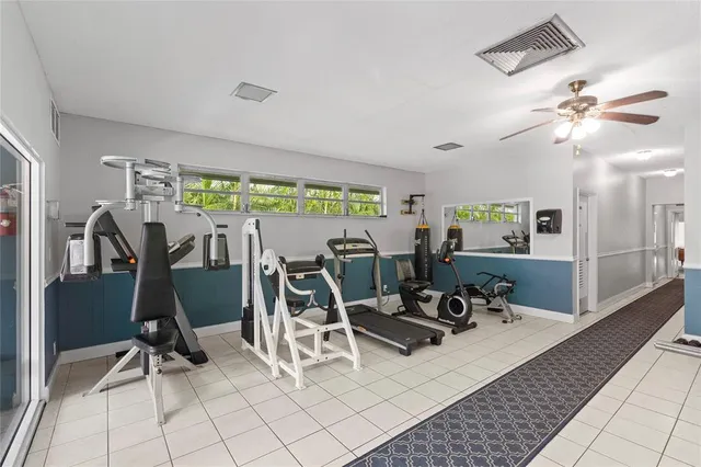a view of a livingroom with furniture and gym equipment