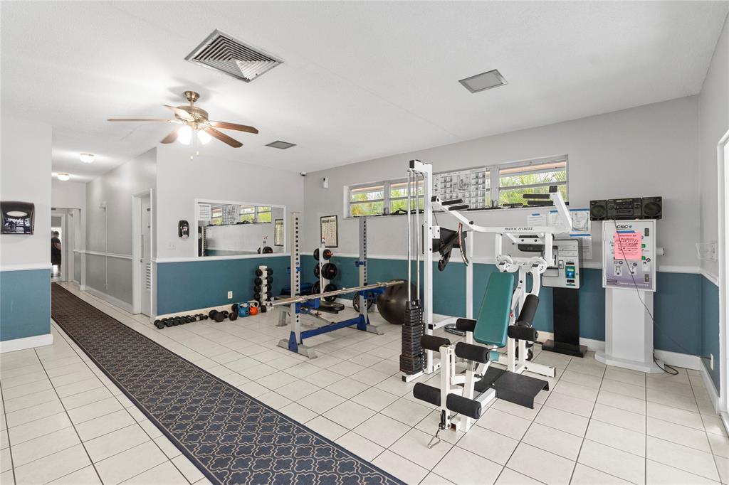 5800 Margate Boulevard, Unit 3463 Margate, FL 33063 - Photo 33 of 37 a view of a livingroom with furniture and gym equipment