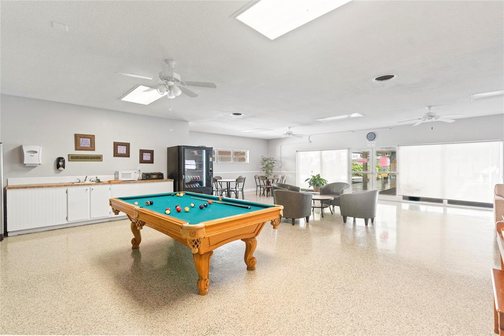 5800 Margate Boulevard, Unit 3463 Margate, FL 33063 - Photo 34 of 37 a room with lots of furniture and view of kitchen