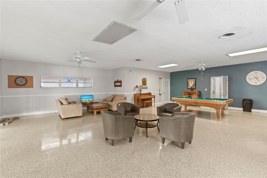 5800 Margate Boulevard, Unit 3463 Margate, FL 33063 - Photo 35 of 37 a living room with furniture and a dining table