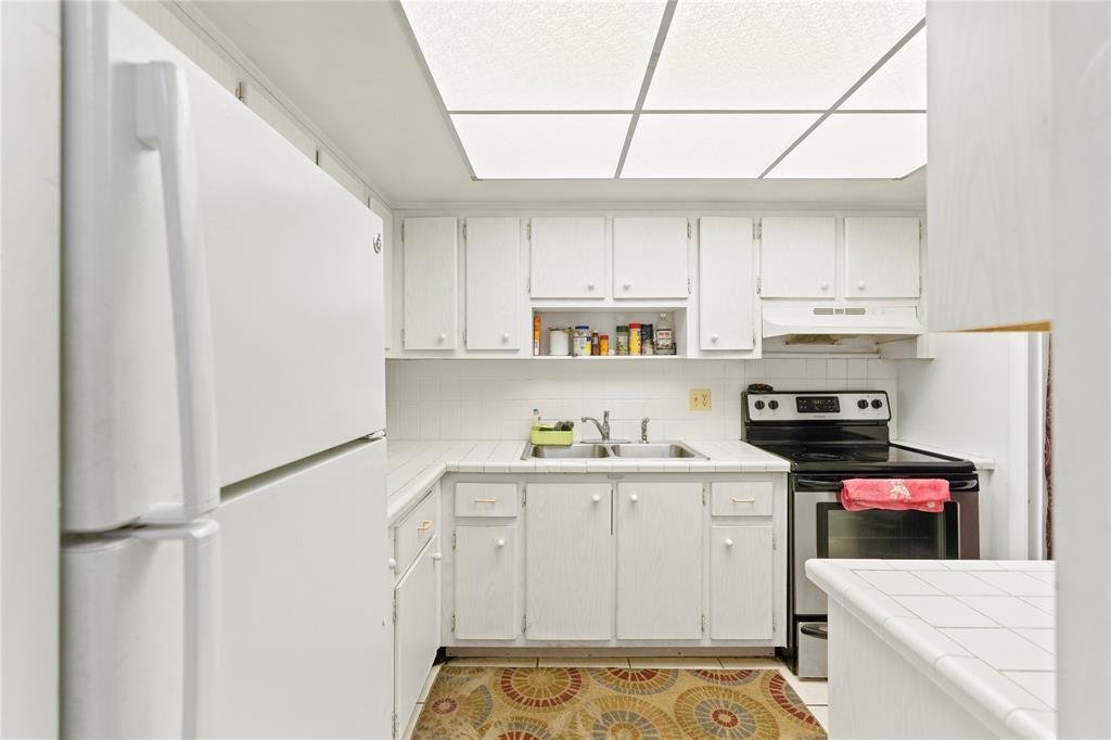 5800 Margate Boulevard, Unit 3463 Margate, FL 33063 - Photo 7 of 37 a kitchen with stainless steel appliances a stove refrigerator sink and cabinets