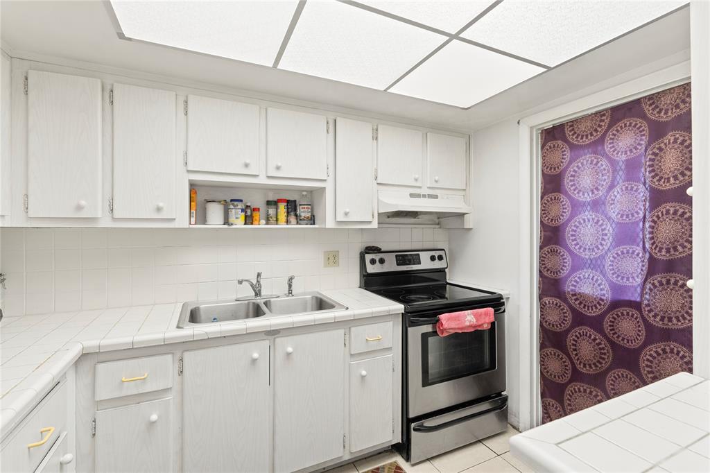 5800 Margate Boulevard, Unit 3463 Margate, FL 33063 - Photo 8 of 37 a kitchen with stainless steel appliances a stove a sink and cabinets