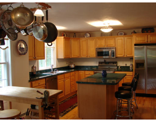 139 Gates Pond Road Berlin, MA 01503 - Photo 5 of 12 a kitchen with stainless steel appliances granite countertop a sink a stove and a wooden floors