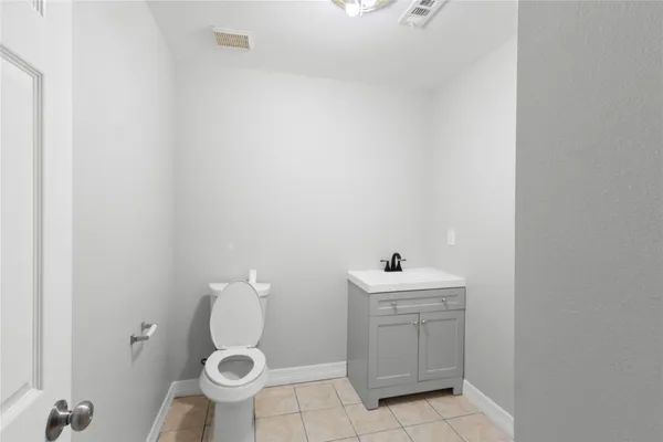 a bathroom with a sink toilet and a mirror