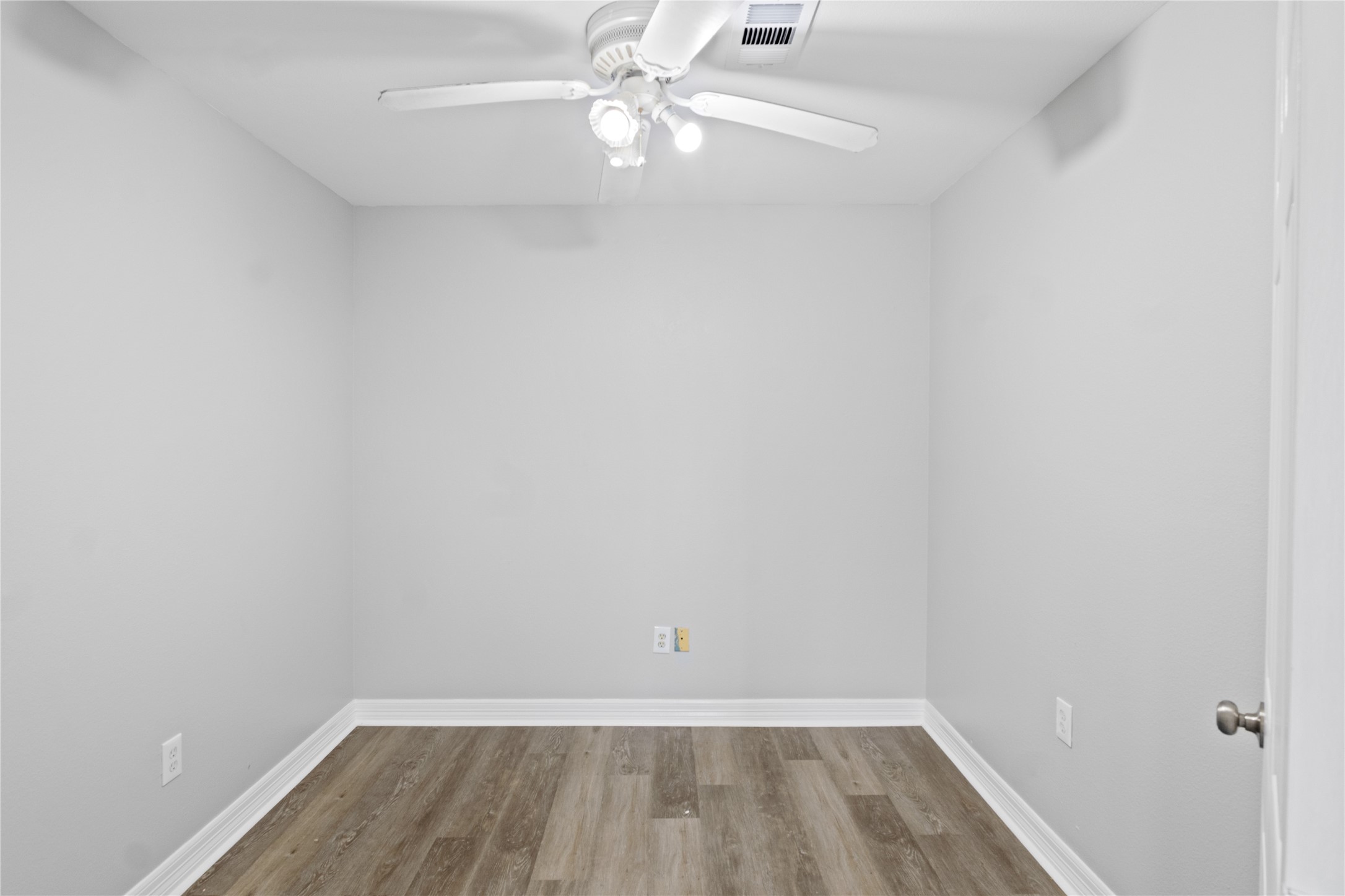 8019 West Fm 517 Road West Dickinson, TX 77539 - Photo 7 of 16 a view of a room with wooden floor and fan