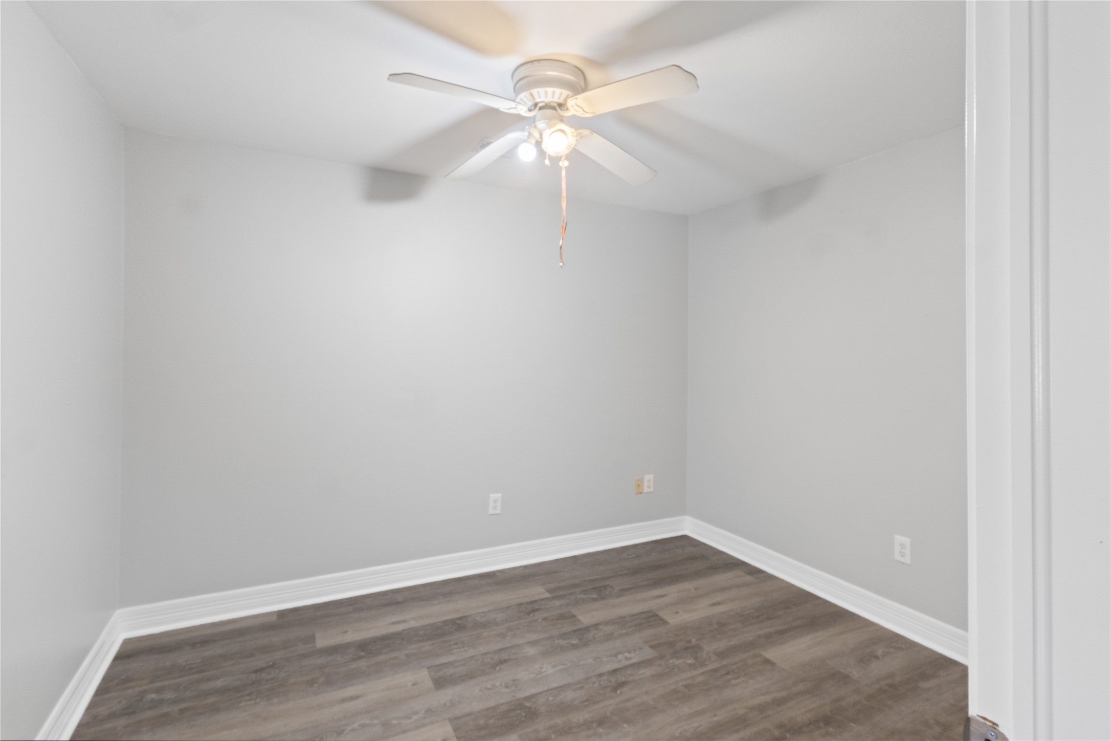 8019 West Fm 517 Road West Dickinson, TX 77539 - Photo 10 of 16 an empty room with a fan and a fan