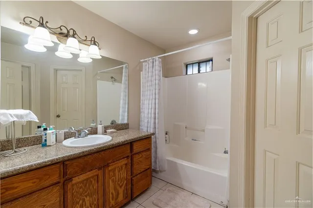 a bathroom with a sink double vanity granite tub and shower
