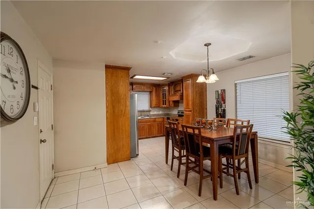 a view of a dining room with furniture and chandelier