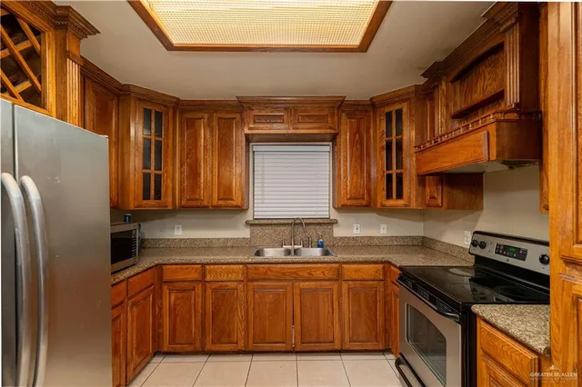 a kitchen with granite countertop stainless steel appliances and wooden cabinets