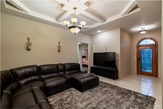 a living room with furniture a ceiling fan and a flat screen tv