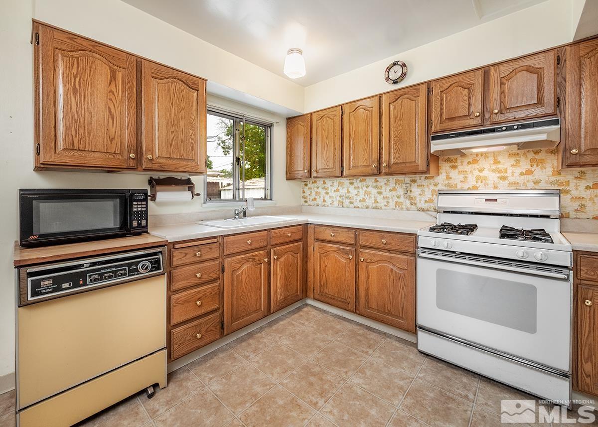 1410 Kirman Avenue Reno, NV 89502 - Photo 8 of 17 a kitchen with granite countertop cabinets stainless steel appliances and a sink